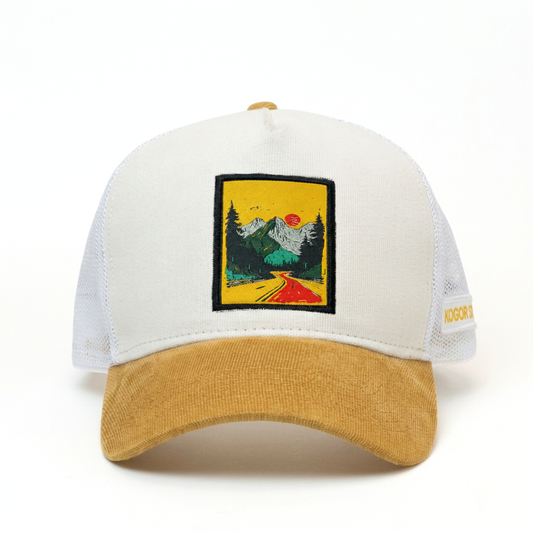 White and yellow cap with a scenic patch on a white background