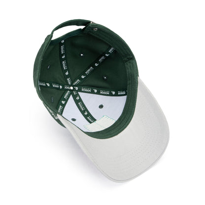 Baseball cap with green top and white brim on a white background
