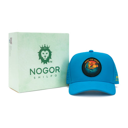 Blue cap with a circular design and 'Nogor Shilpo' box on a white background
