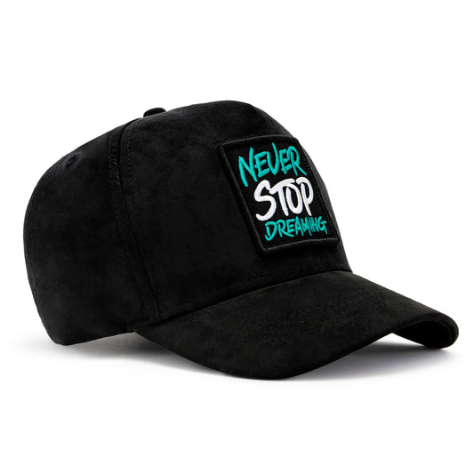 Black cap with 'Never Stop Dreaming' patch on a white background