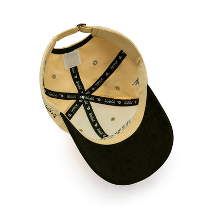 Beige and black cap with branding on a white background