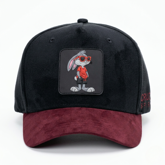 Black and red cap with cartoon character patch on a white background