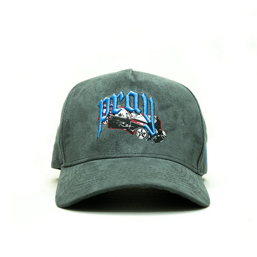 Green cap with embroidered design on a white background