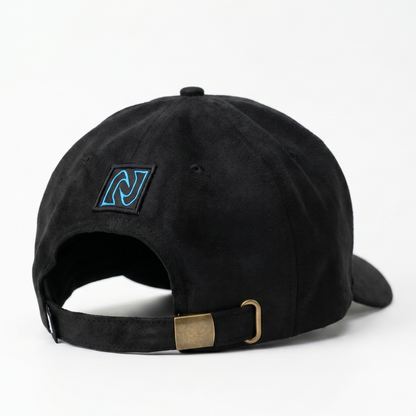 Black cap with a blue logo and gold tag on a white background