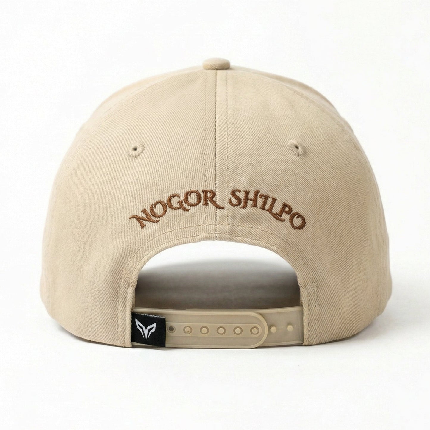 Beige cap with 'Nogor Shilpo' embroidery on a white background
