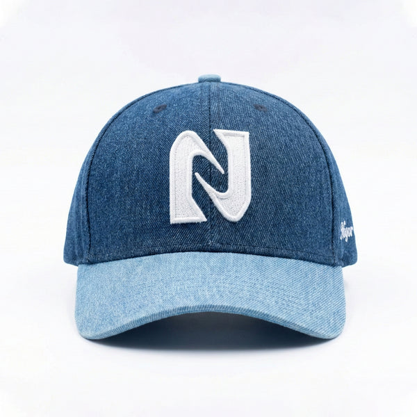 Blue denim cap with a white logo on a light gray background
