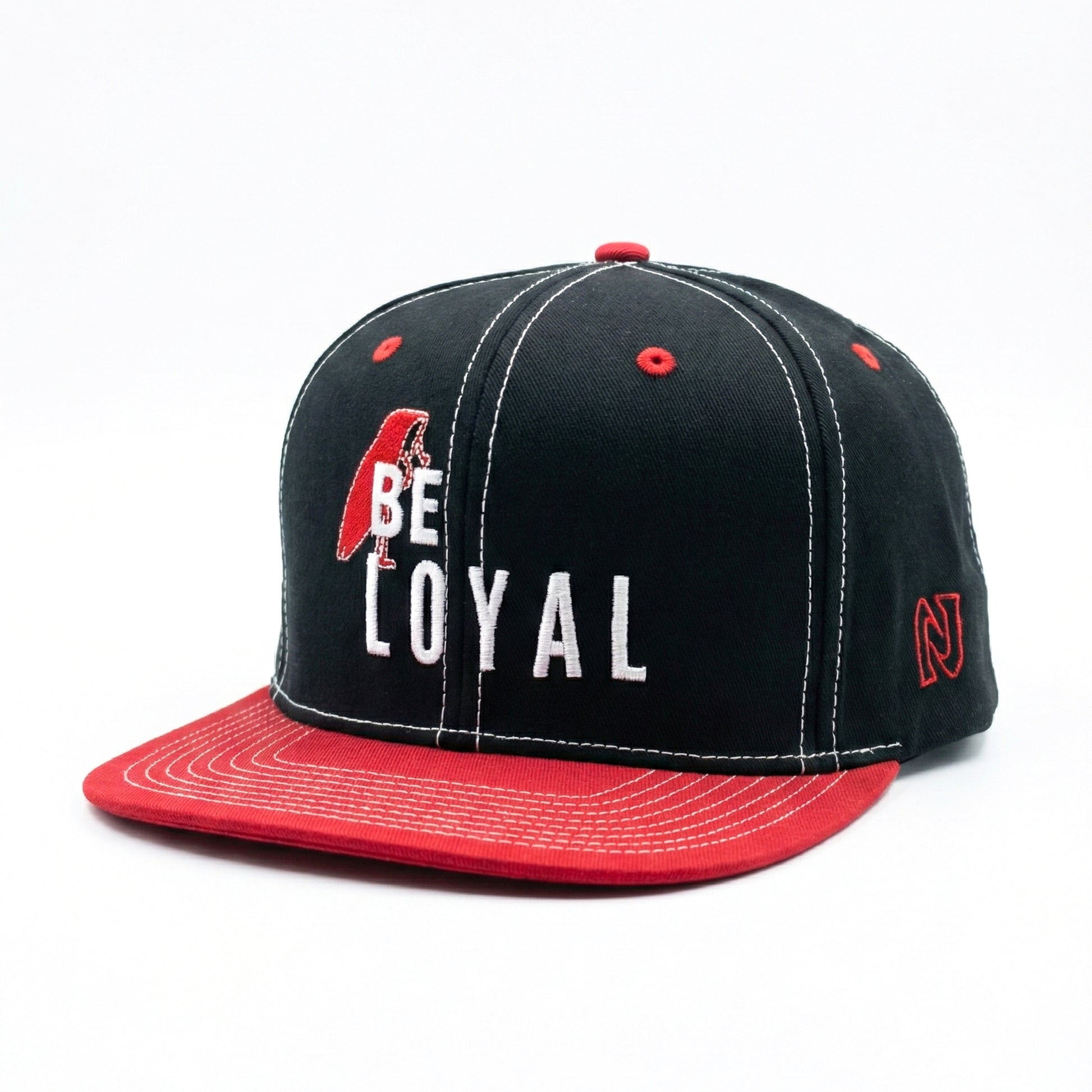 Black and red cap with 'BE LOYAL' text on a white background