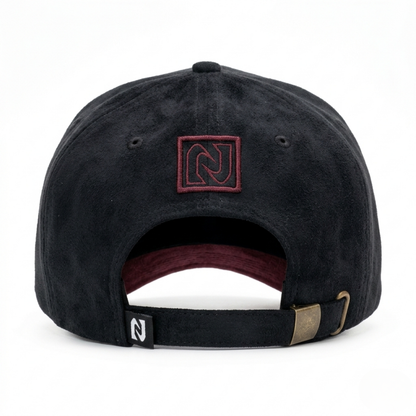 Black cap with a logo on the back against a white background