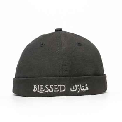 Black cap with 'BLESSED' embroidered on a white background